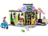 Front exterior of LEGO Heartlake City Cafe with minifigures and scooter.