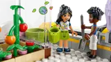 Minifigures gardening on the rooftop greenhouse.