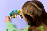 Overhead view of girl playing with set.