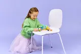 Girl playing with LEGO Friends store.