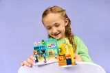 Girl holding LEGO Friends store.