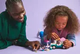 Adult and child playing with LEGO set.