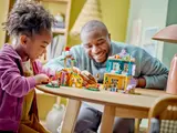 Child and adult building LEGO Friends Preschool.