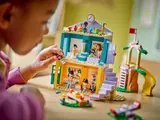 Child playing with LEGO Friends preschool building.