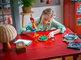 Child building Heihei with tablet.
