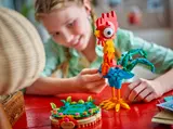 Child handling Heihei's base.