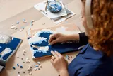 Builder assembling LEGO Great Wave.