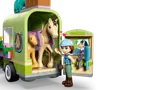 Autumn minifigure at open horse trailer with horses and grooming accessories.