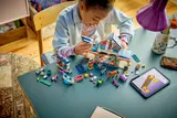 Child building LEGO Friends Stable.