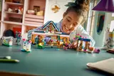 Child playing with LEGO Friends Stable.