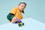 Child playing with the hot rod.