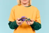 Child holding the LEGO hot rod.