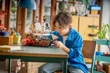 Child playing with LEGO Pirate Ship.