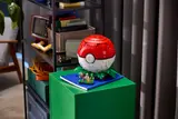 Poké Ball on a green cabinet.