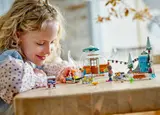 Child playing with igloo set.