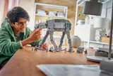 Builder adjusting LEGO AT-AT head.