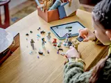 Child building LEGO with tablet instructions.