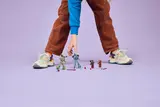 Child reaching for the LEGO Iron Man, War Machine, and drones.