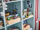 Multiple LEGO postcard sets on a shelf.