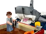 Hooper minifigure facing the shark's open jaws.