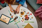 Child building LEGO Ninjago vehicles with digital instructions.