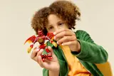 Child inspects Kai's Dragon Mech.