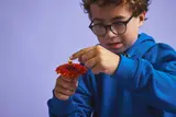Child adjusting Kai in spinner.