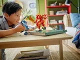 Child playing with Ninjago mechs.
