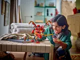 Child playing with Ninjago mech.