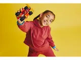 Child holding NINJAGO car.
