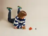 Child reacts to scattered LEGO Ninjago pieces.