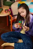 Child holding Kakamora figure.