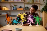 Person building yellow figure.