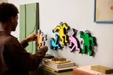 Wall-mounting a dancing figure.