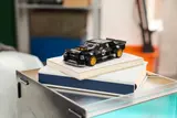 LEGO Hoonicorn on books, angled view.