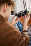 Close-up of hands holding LEGO Hoonicorn.