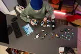 Kid building Kit mech on a desk.