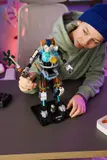 Kid interacting with Kit mech and minifigure.