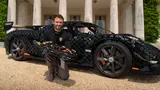 Designer with real car and LEGO model.