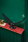 Shuttle on narrow shelf, green wall.