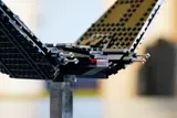 Close-up on shuttle cockpit and wing joint.
