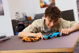 Child playing with LEGO Lamborghini models.