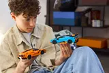 Child examining LEGO Lamborghini cars.