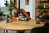 Man admiring LEGO Land Rover Classic Defender 90.