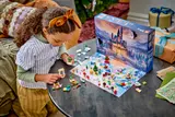 Child playing with fully built LEGO calendar
