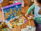 Overhead view of child playing with LEGO Friends calendar.
