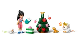 Aliya decorating a Christmas tree with animals.