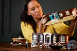 Person holding modular house section.
