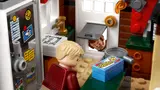 Kevin in kitchen with pizza and dog flap.