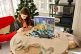 Child building LEGO Advent Calendar piece.